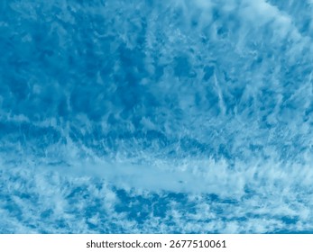 Cloud formations in the blue sky captured on a clear day showing soft cirrus patterns.