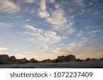 Cloud formations at sunset with rocks
