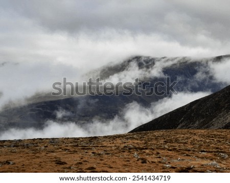 Cloud inversion, above clouds, Brocken spectre in Wales, Eryri, Snownonia, the UK. Beautiful sunny day in National Park.