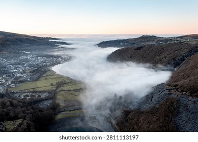 Cloud inversion covering Llyn Padarn lake and Llanberis village in Eryri National Park, Wales, during early morning