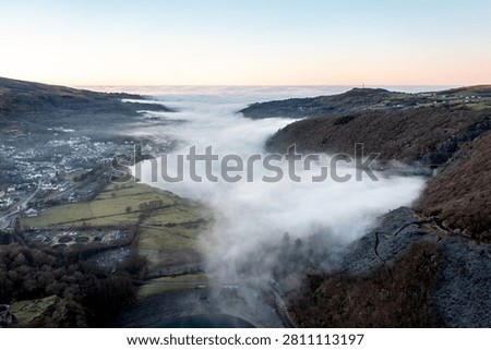 Cloud inversion covering Llyn Padarn lake and Llanberis village in Eryri National Park, Wales, during early morning