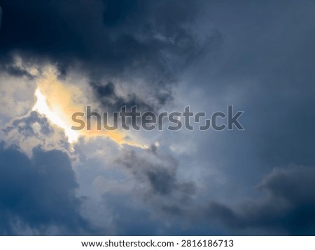 Cloud iridescence is a phenomenon where clouds radiate a beautiful pastel rainbow of colors as a storm brews in the dark, gloomy sky.