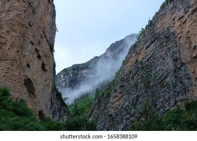 Cloud passing though two mountains