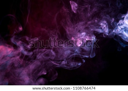 Cloud of  pink and purple smoke on a black isolated background. Background from the smoke of vape