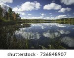 Cloud reflections dance across the smooth surface of a North Woods lake on a pleasant autumn afternoon in northern Wisconsin.