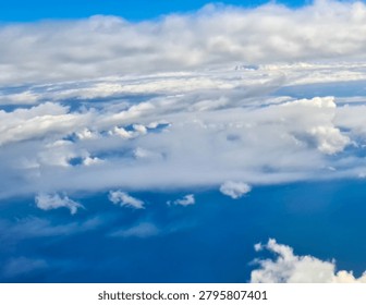 Cloud ridges seen from an airplane window. The boundary between the troposphere and stratosphere. Travel and environment concept.