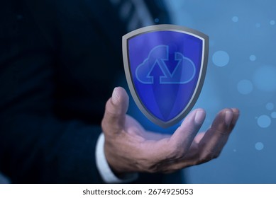 Cloud Security and Data Protection Concept. Businessman holding shield protect cloud security icon, data, and technology, representing cybersecurity, privacy, and secure cloud storage.