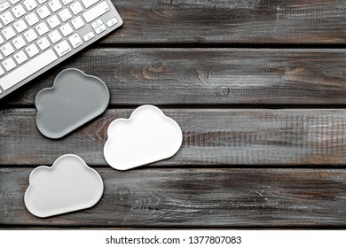 cloud service concept with clouds and keyboard on wooden background top view mockup
