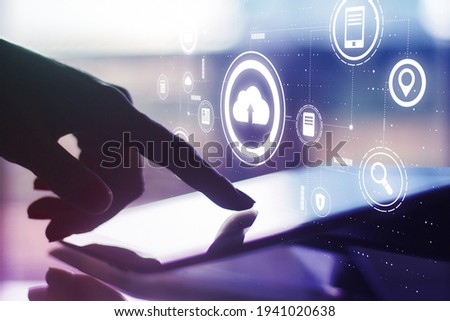 Cloud service concept with digital cloud application icons on man finger touching digital tablet screen background