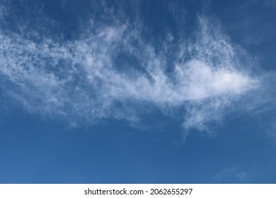 A Cloud In The Shape Of A Bat Flying In The Blue Sky Is Seen At Around 5 Pm. This Image Is Good For Texture Or Background Prints.