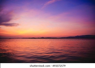 cloud and sky over lake before sunrise and water reflection at southern Thailand,select focus at stone on foreground,ideal use for background,dark edges image.