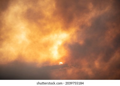 Cloud of smoke from a fire on sunset
