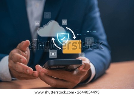 Cloud storage and data protection concept with businessman using smartphone to upload and access encrypted digital files via secure mobile app for business data management and privacy protection.