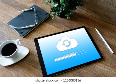 Cloud synchronization progress bar on tablet screen. Data storage and protection. Technology and internet concept.