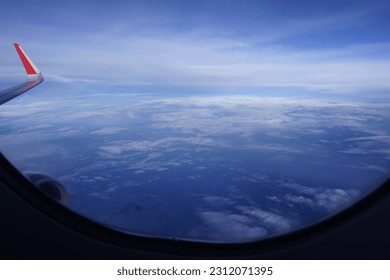 cloud view from airplane window - Shutterstock ID 2312071395