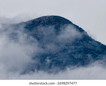 cloudcovered mountain surface exploration, overcast granite hillside with subdued surveying