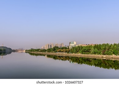 Cloudless riverside covered with a few