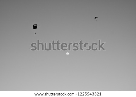 
cloudless sky with moon and parachute
