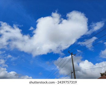 a clouds background and a electric pole