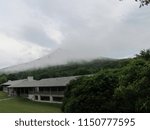 clouds begin to hide sharp top peak as rain moves in to housing at Peaks of Otter, Bedford, VA, USA