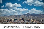 Clouds and blue skies over El Paso, Texas and Juarez, Mexico.  The inscription on the mountain reads "la Biblia es la verdad, leela" which translated means "the bible is the truth, read it."