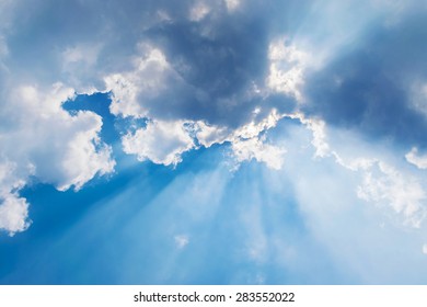 Clouds In Blue Sky With Sun Rays