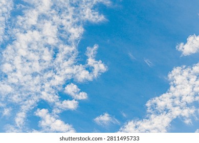 Clouds create patterns in the sky during a sunny day with clear blue colors that show a relaxed atmosphere in the afternoon.