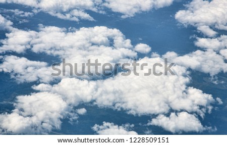 clouds in dark blue sky birdflight view
