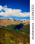 Clouds float on the brilliant blue sky over the Colorado Rockies along the Continental Divide in Rocky Mountain National Park