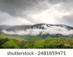 Clouds float over the mountain peaks during the rainy season at Sapun, Bo Kluea, Nan, Thailand.