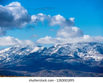 Clouds float over snow capped mountains, Idaho.