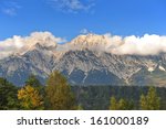 Clouds floating above snow capped mountains in Austria