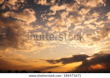 Similar – Foto Bild Wolken mit Sonnenstrahlen vor bergigen Vordergrund