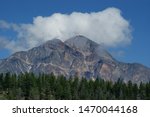 Clouds floating over mountains, featuring the Canadian Rockies in Alberta, Canada.