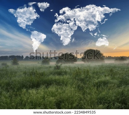 clouds in the form of a world map over a picturesque meadow. travel and landscape concept. spring meadow