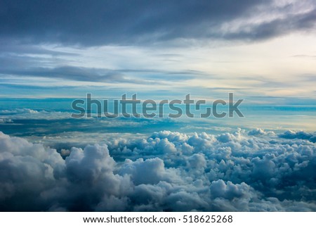 Clouds formation during sunrise seen through the window of an airplane.