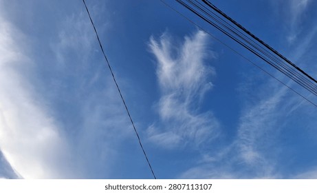 Clouds forming a wing shaped pattern across the sky