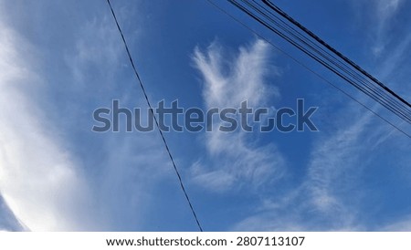 Clouds forming a wing shaped pattern across the sky