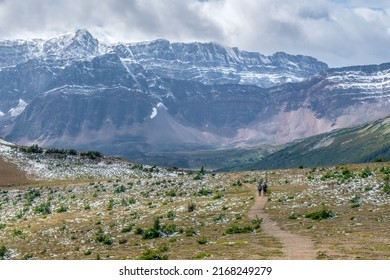 Clouds Gathering Above The Mountain Range In Canadian Rockies. Jasper National Park, Alberta, Viewed From Bald Hills Trail. Cloudy Summer In Canadian Rockies. Couple Walking In The Mountains.