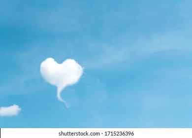 Clouds heart shaped patterns on bright blue sky background , copy space