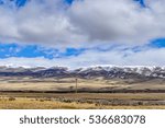Clouds hover over the high ground and plain in the big sky country of Montana.