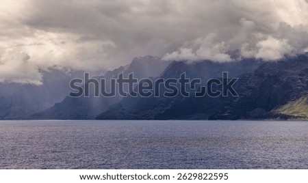 Clouds loom over the cliffs and ocean at the Na Pali Coast, Hawaii.