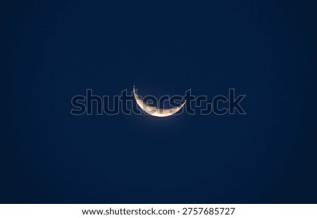Clouds obstruct the Moon's visibility on Chand Raat (the night of moon-sighting for Eid) in most parts of India. On the day after Eid, the Waxing Crescent Phase Moon has risen in the western sky through the vegetation at Tehatta, West Bengal, India. This is the first Phase after the New Moon.
