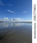 Clouds over the beach during low tide 