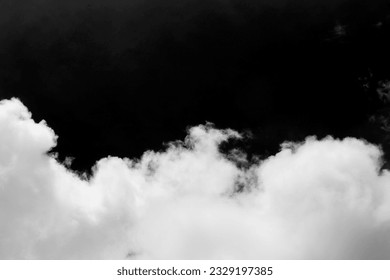 Clouds over black background .	