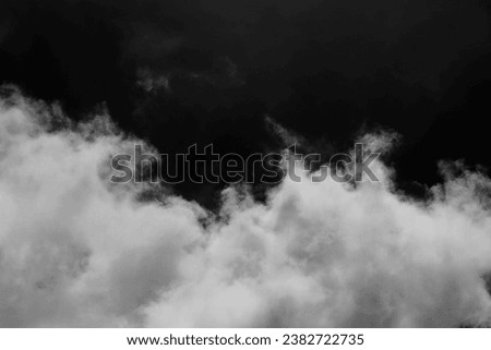 Clouds over black background .