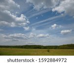 clouds over meadow and forest