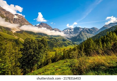 Clouds over the peaks of a mountain valley. Beautiful mountain landscape. Mountain clouds landscape. Mountain peak clouds view