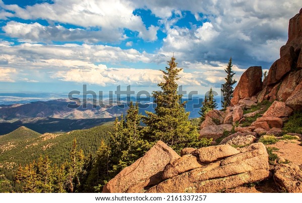 Clouds over red rocks landscape. Mountain gill\
valley rocks under sky clouds. Mountain rocks on cloudy sky\
background. Mountain rocks\
landscape
