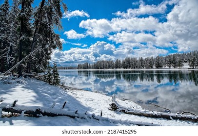 Clouds over the river in the winter snow forest background. Winter river on wintertime background